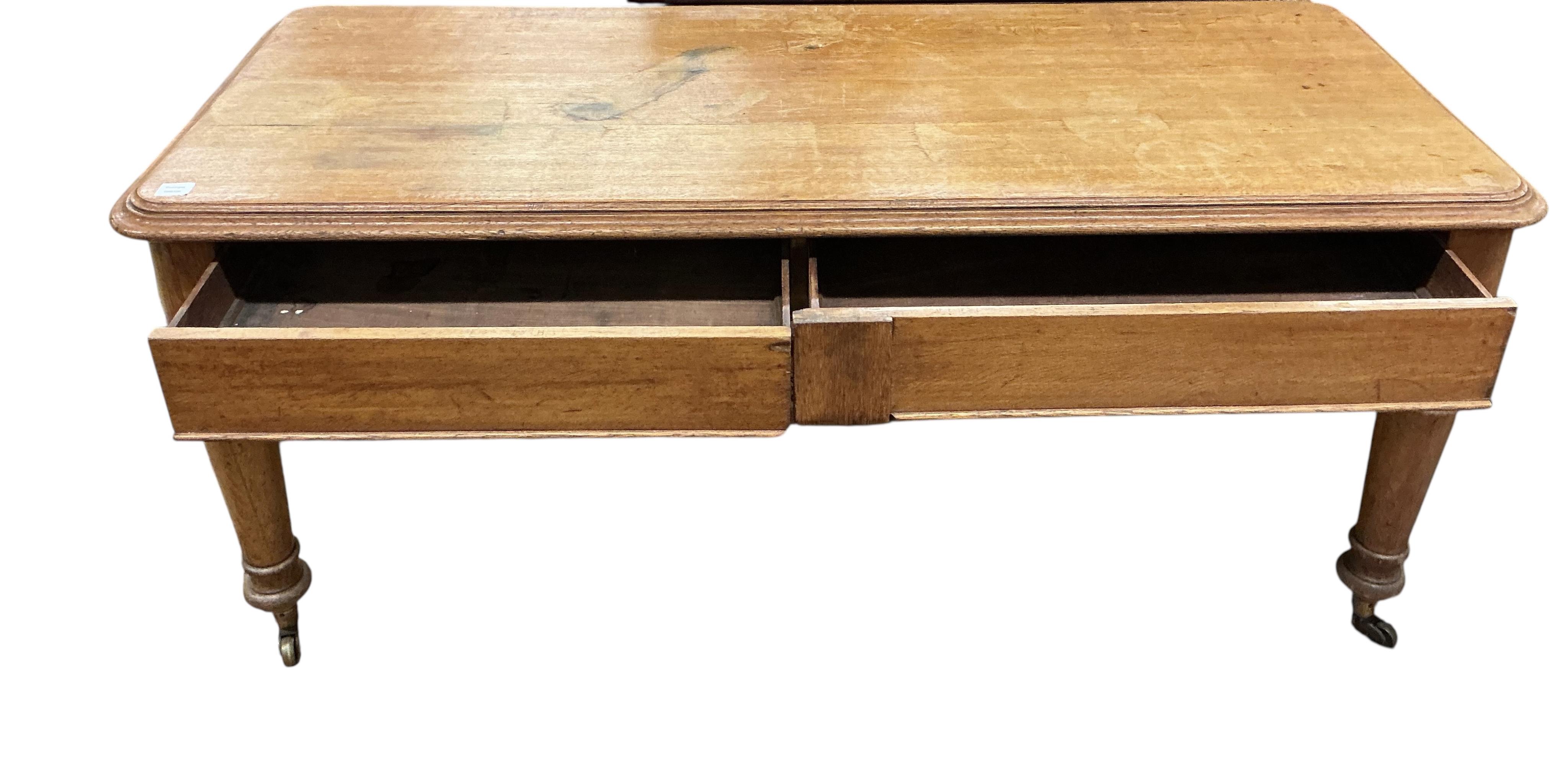 A Victorian light oak side table, fitted two drawers, on turned legs, width 180cm, depth 74cm, height 80cm